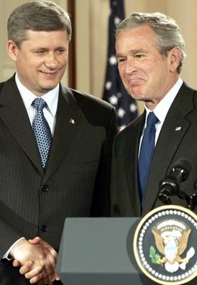 Stephen Harper checks George Bush’s shirt for lipgloss stains.