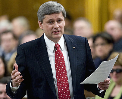 Stephen Harper trying out Roger Ebert’s hair piece in public for the first time